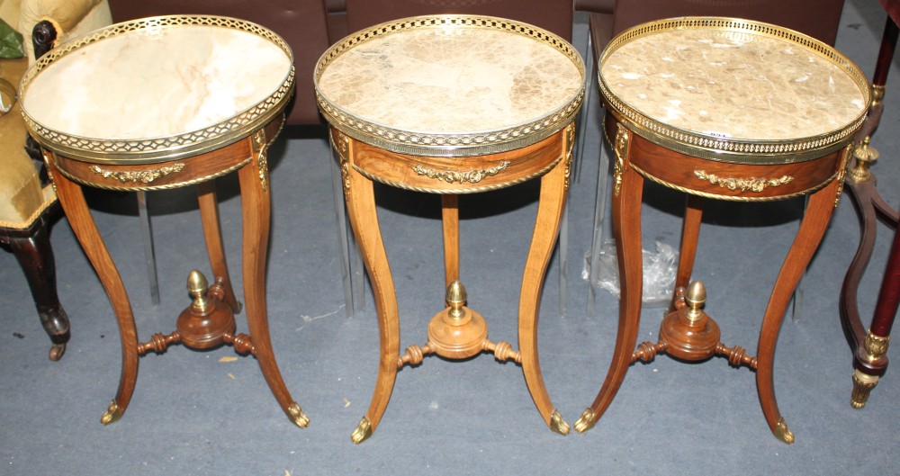 A near set of three Meuble Francais marble topped occasional tables, Diam.40cm H.67cm